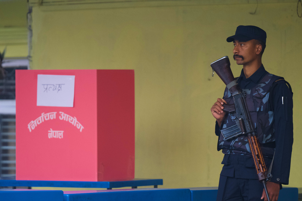 A Nepalese police officer stands guard near a ballot box as the voting commences for the parliamentary election in Kathmandu, Nepal, Thursday, March 5, 2026. (AP Photo/Niranjan Shrestha)