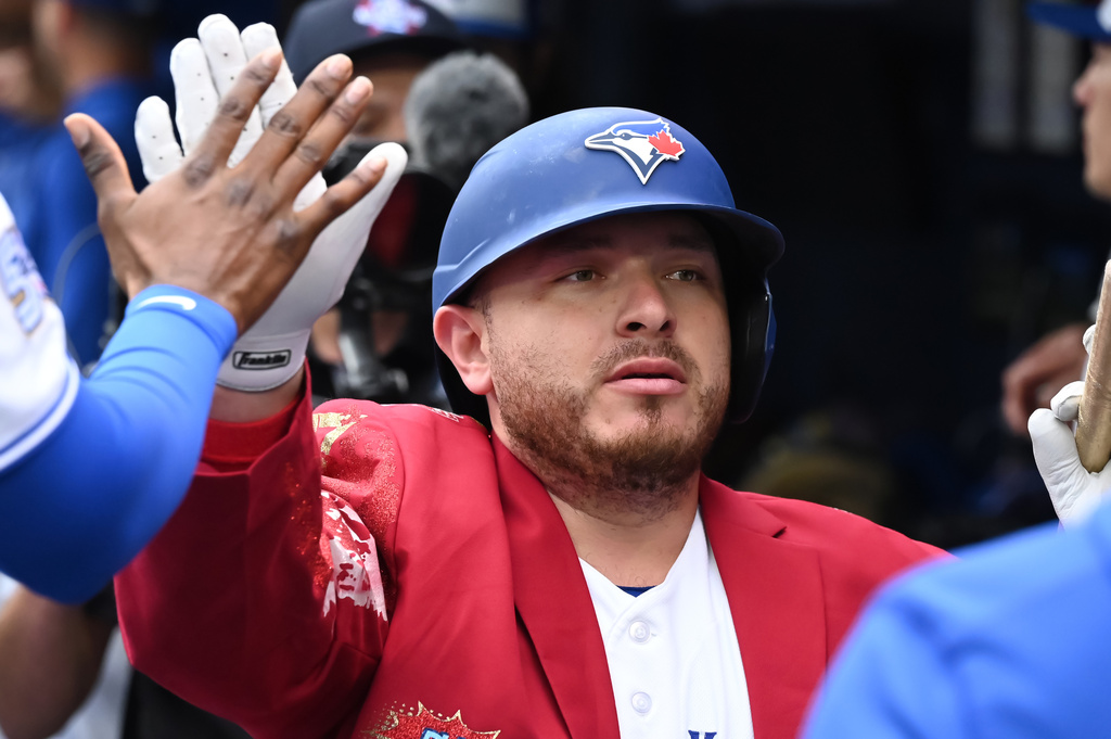 Toronto Blue Jays' Alejandro Kirk celebrates in the dugout after hitting a two-run home run against the Seattle Mariners during the first inning of a baseball game in Toronto, Sunday, Aug. 30, 2026. (Jon Blacker/The Canadian Press via AP)