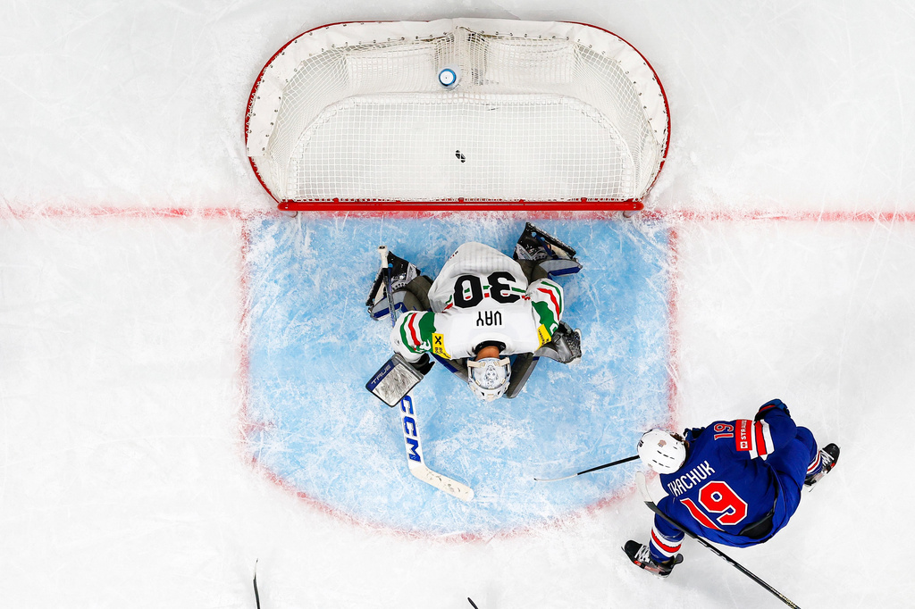 Matthew Tkachuk of the U.S., right, scores against Hungary's goaltender Adam Vay during the 2026 IIHF Men's Ice Hockey World Championship preliminary round group A game between United States and Hungary, in Zurich, Switzerland, Monday, May 25, 2026. (Andreas Becker/Keystone via AP)