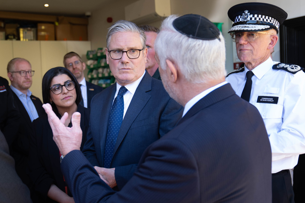 Britain's Prime Minister Keir Starmer, center, Metropolitan Police Commissioner Mark Rowley, right, and Home Secretary Shabana Mahmood, 2nd left, speak with members of the Jewish community during a visit to Golders Green, north west London, Thursday April 30, 2026, following an attack on Wednesday in which two men were stabbed. (Stefan Rousseau/Pool via AP)