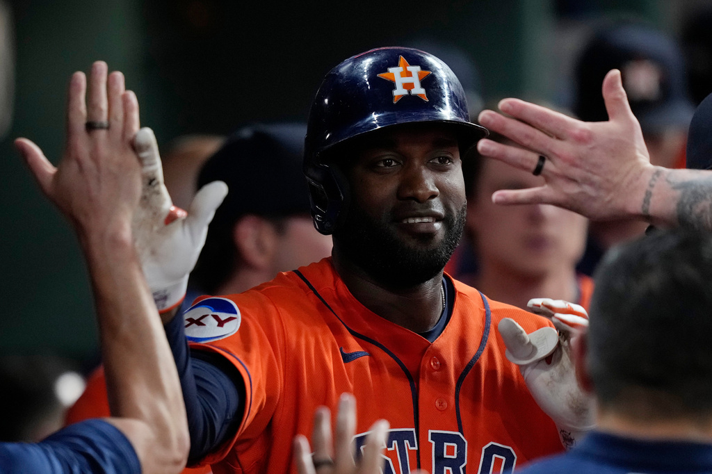 Houston Astros designated hitter Yordan Alvarez is congratulated in the dugout after hitting a solo home run during the sixth inning of a baseball game against the Tampa Bay Rays, Friday, July 3, 2026, in Houston. (AP Photo/Kevin M. Cox)