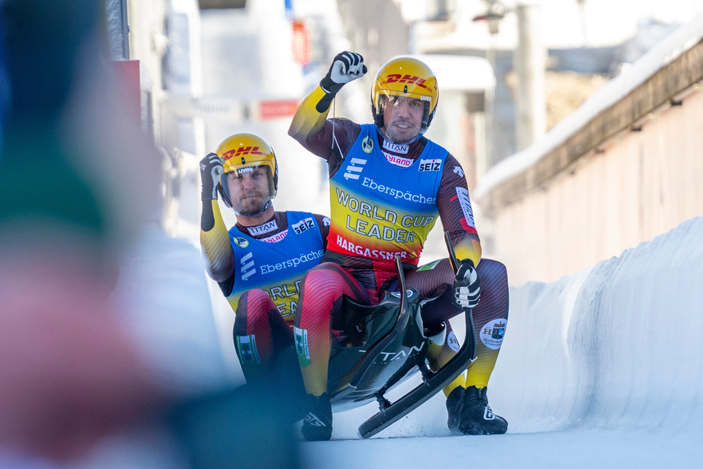 Tobias Wendl and Tobias Arlt of Germany celebrate their victory in the doubles men competition of the Luge World Cup in Winterberg, Germany, Sunday Jan. 11, 2026. (David Inderlied/dpa via AP)