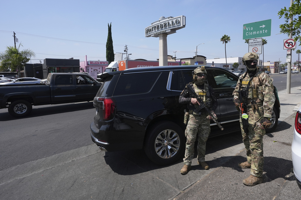 FILE - Immigration agents conduct an operation at a car wash Aug. 15, 2025, in Montebello, Calif. (AP Photo/Gregory Bull, File)