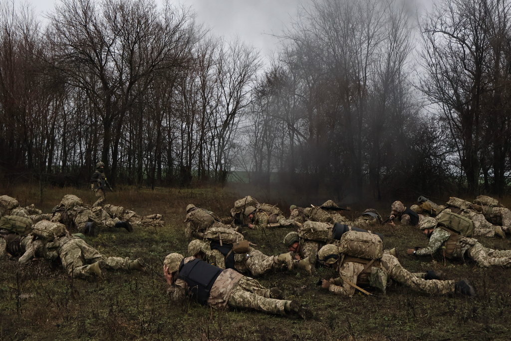In this photo provided by Ukraine's 65th Mechanized Brigade press service, recruits attend drills at a training ground in the Zaporizhzhia region, Ukraine, Friday, Dec. 12, 2025. (Andriy Andriyenko/Ukraine's 65th Mechanized Brigade via AP)