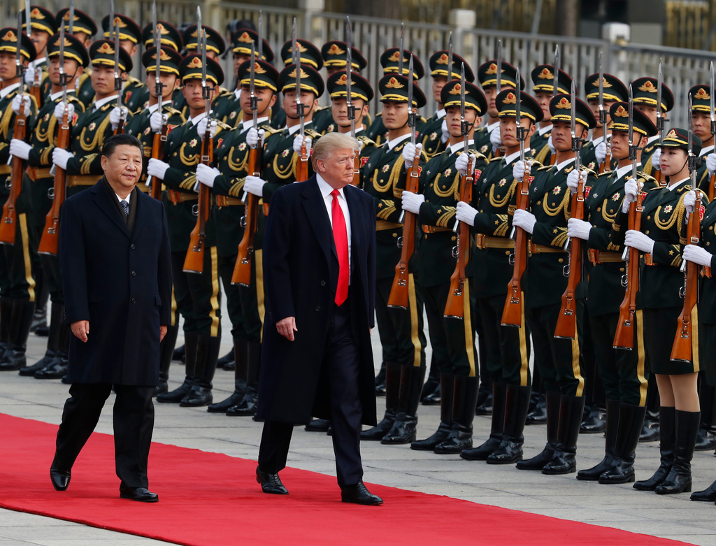 FILE - U.S. President Donald Trump, right, and Chinese President Xi Jinping inspect a honor guard during a welcome ceremony at the Great Hall of the People in Beijing, Nov. 9, 2017. (AP Photo/Andy Wong, File)