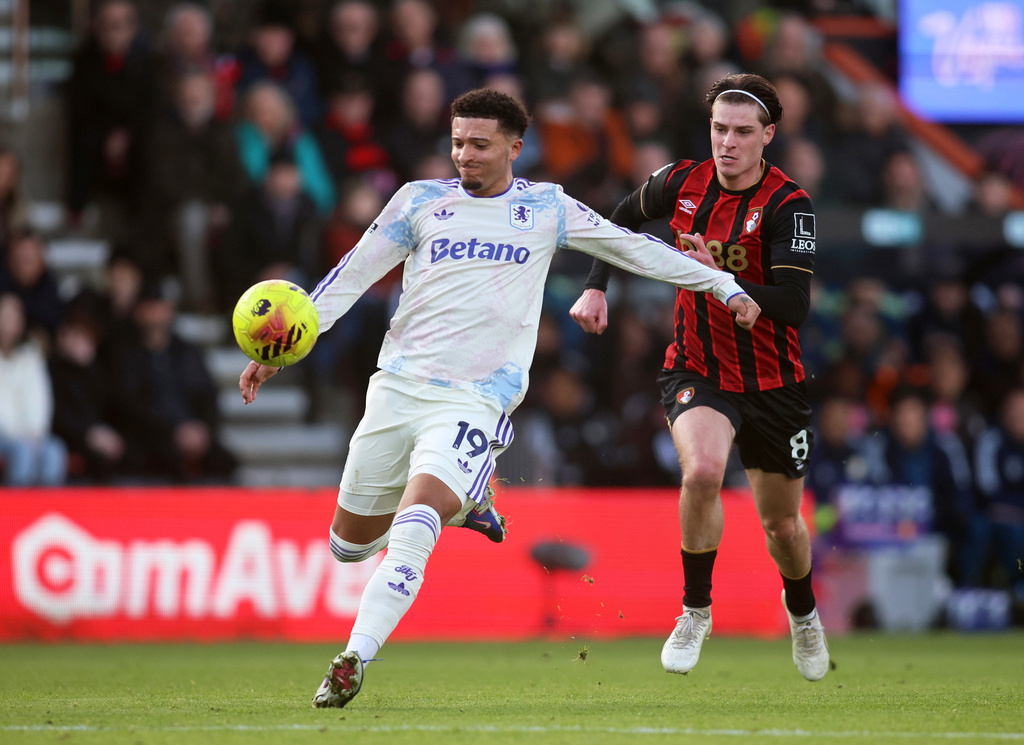Aston Villa's Jadon Sancho, left, and Bournemouth's Alex Scott battle for the ball during their English Premier League soccer match in Bournemouth, England, Saturday, Feb. 7, 2026. (Peter Tarry/PA via AP)