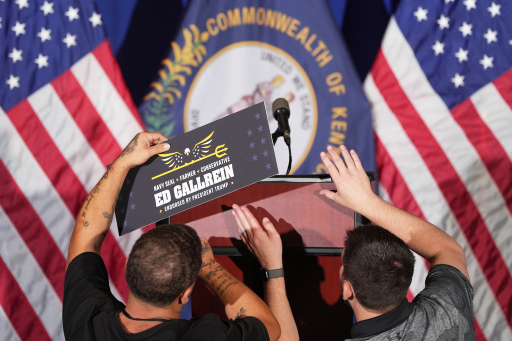 Workers attach a sign for Republican congressional candidate Ed Gallrein before he speaks at an election night event Tuesday, May 19, 2026, in Covington, Ky. (AP Photo/Joshua A. Bickel)
