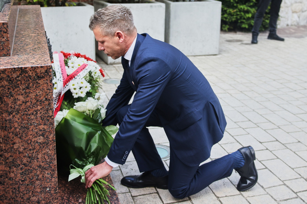 Hungarian Prime Minister Peter Magyar lays down flowers at a monument for late Pope John Paul II, at the Wawel Cathedral during his visit in Krakow, Poland Tuesday, May 19, 2026. (AP Photo/Beata Zawrzel)