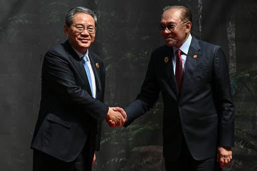China's Premier Li Qiang, left, shakes hands with Malaysia's Prime Minister Anwar Ibrahim as he arrives at the Kuala Lumpur Convention Centre to attend the 47th Association of Southeast Asian Nations (ASEAN) summit in Kuala Lumpur, Malaysia, Monday, Oct. 27, 2025. (Lillian Suwanrumpha/Pool Photo via AP) China's Premier Li Qiang, left, shakes hands with Malaysia's Prime Minister Anwar Ibrahim as he arrives at the Kuala Lumpur Convention Centre to attend the 47th Association of Southeast Asian Nations (ASEAN) summit in Kuala Lumpur, Malaysia, Monday, Oct. 27, 2025. (Lillian Suwanrumpha/Pool Photo via AP)