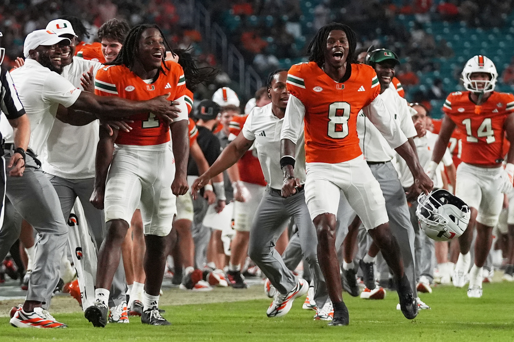 Miami wide receiver Malachi Toney (1) and wide receiver Vandrevius Jacobs (8) celebrate after wide receiver Vance Spafford scored a touchdown during the second half of an NCAA college football game against Florida A&M, Thursday, Sept. 10, 2026, in Miami Gardens, Fla. (AP Photo/Lynne Sladky)