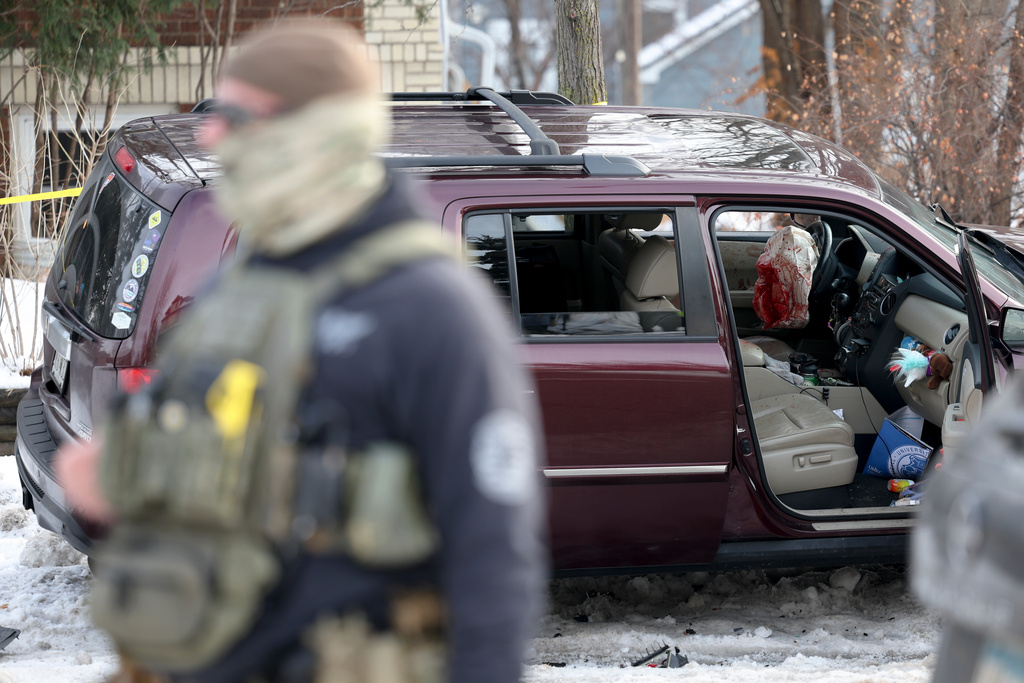 A deployed airbag and blood stains are seen in a crashed vehicle on at the scene of a shooting in Minneapolis on Wednesday, Jan. 7, 2026. (Ellen Schmidt/MinnPost via AP)