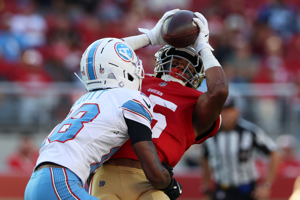San Francisco 49ers wide receiver De'zhaun Stribling, right, catches a pass against Tennessee Titans defensive back Cor'Dale Flott during the first half of a preseason NFL football game, Thursday, Aug. 13, 2026, in Santa Clara, Calif. (AP Photo/Jed Jacobsohn)