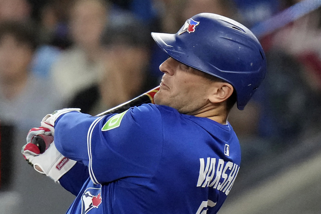 Toronto Blue Jays' Daulton Varsho (5) hits a grand slam home run off Boston Red Sox pitcher Justin Wilson during sixth inning MLB baseball action in Toronto on Thursday Sept. 25, 2025. (Chris Young/The Canadian Press via AP)