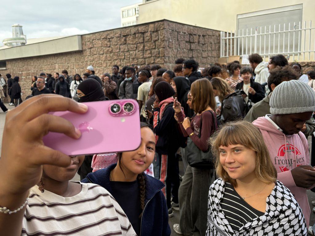 Activist Greta Thunberg poses as she attends a gathering in front of Paul Eluard high school during a protest against under-resourced schools in Saint-Denis, outside Paris, Tuesday Oct. 13, 2026. (AP Photo/John Leicester)