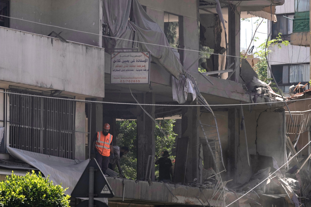 A rescue worker checks an apartment that was hit in an Israeli airstrike in Dahiyeh, Beirut's southern suburbs, Lebanon, Sunday, June 14, 2026. (AP Photo/Bilal Hussein)