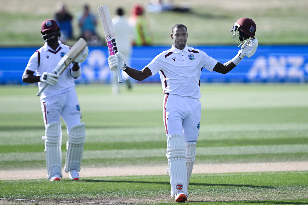 West Indies' Justin Greaves, right, raises his bat after scoring 200 runs against New Zealand on Day 5 of their cricket test match in Christchurch, New Zealand, Saturday, Dec. 6, 2025. (Andrew Cornaga/Photosport via AP)
