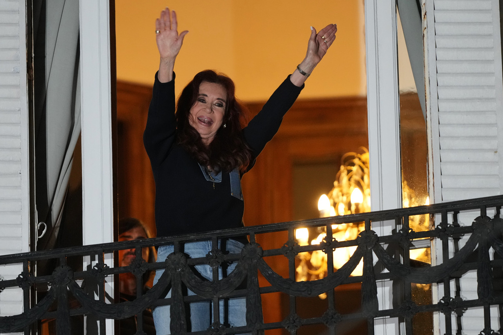 Former Argentine President Cristina Fernandez, who is serving a prison sentence under house arrest for corruption, waves from the balcony of her home during a rally marking the fourth anniversary of the assassination attempt against her in Buenos Aires, Argentina, Tuesday, Sept. 1, 2026. (AP Photo/Natacha Pisarenko)