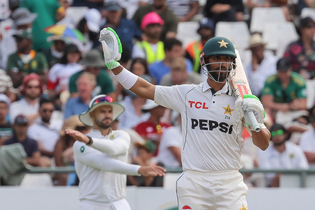 FILE - Pakistan's Shan Masood, foreground, gestures during the third day of the second test cricket match between South Africa and Pakistan, in Cape Town, South Africa, Sunday, Jan. 5, 2025. (AP Photo/Halden Krog, File)