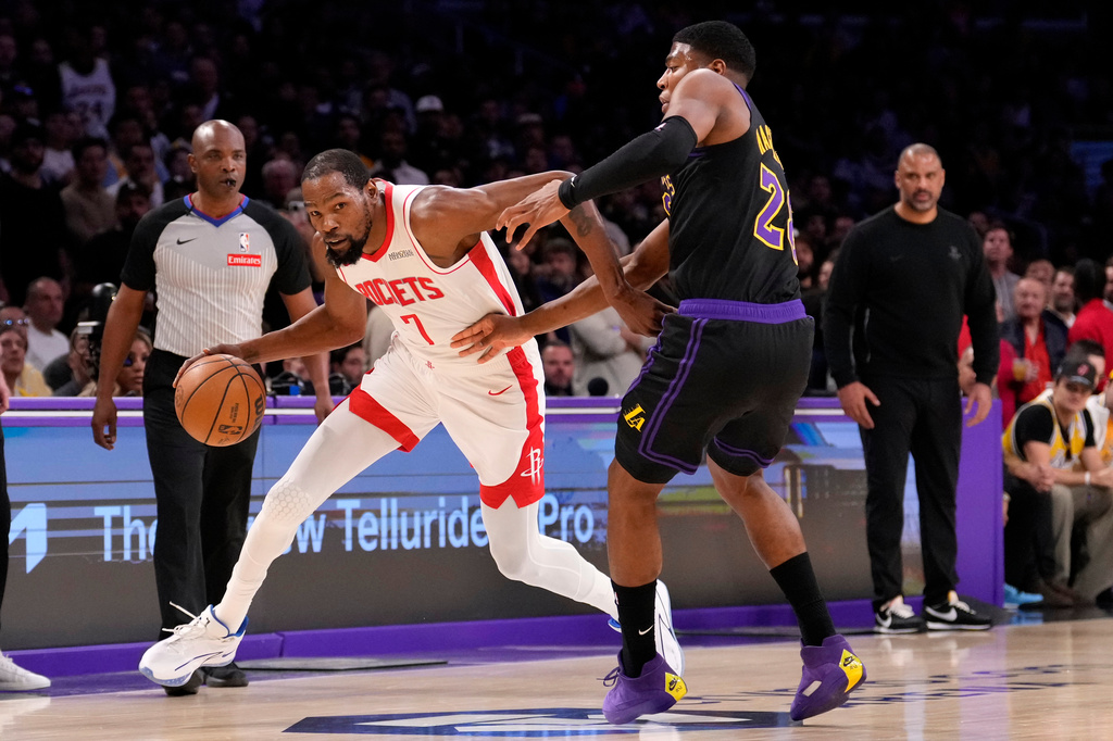 Houston Rockets forward Kevin Durant, left, drives by Los Angeles Lakers forward Rui Hachimura during the first half in Game 2 of a first-round NBA playoffs basketball series Tuesday, April 21, 2026, in Los Angeles. (AP Photo/Mark J. Terrill)