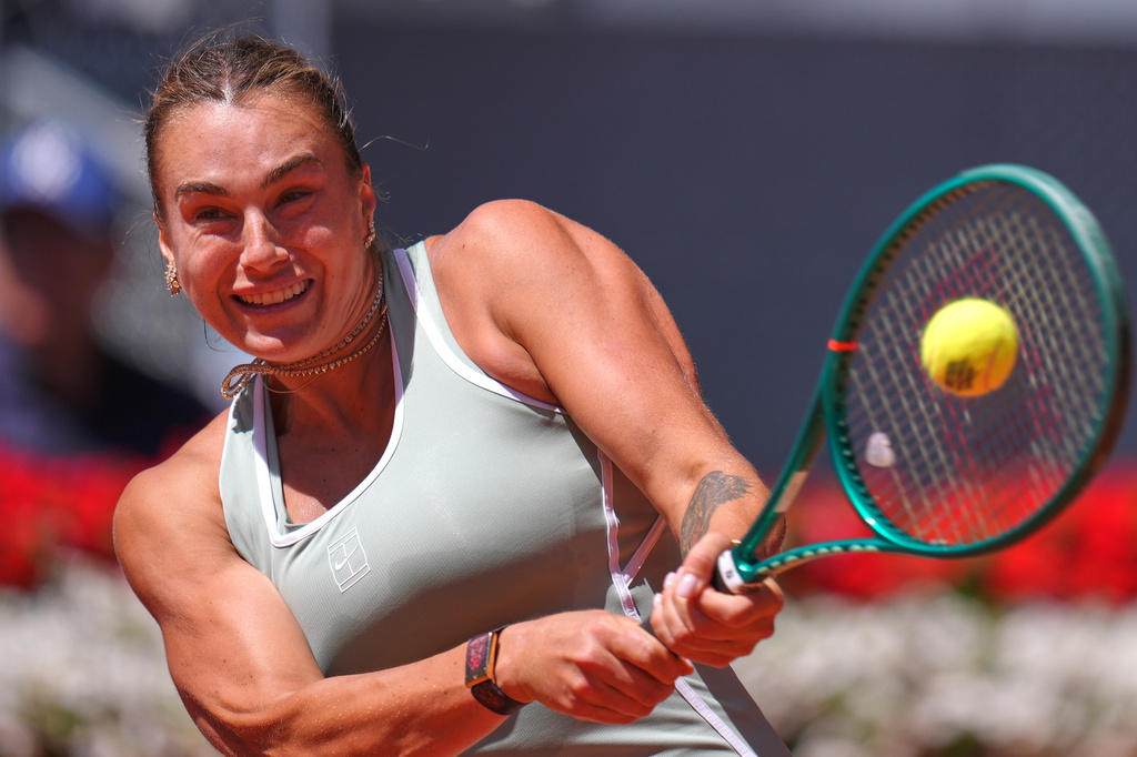 Aryna Sabalenka of Belarus returns the ball to Naomi Osaka of Japan during the Madrid Open tennis tournament in Madrid, Monday, April 27, 2026. (AP Photo/Manu Fernandez)