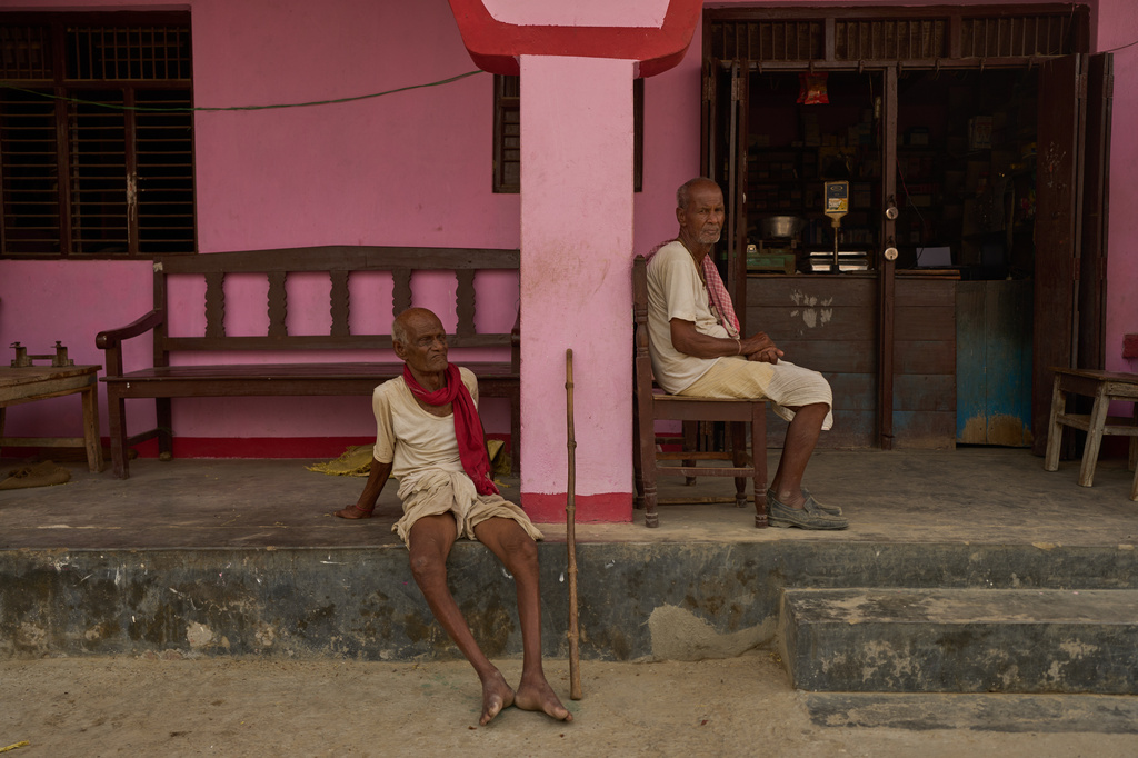 Men sit outside a store in Gaur, Nepal, on May 19, 2026. (AP Photo/Bram Janssen)