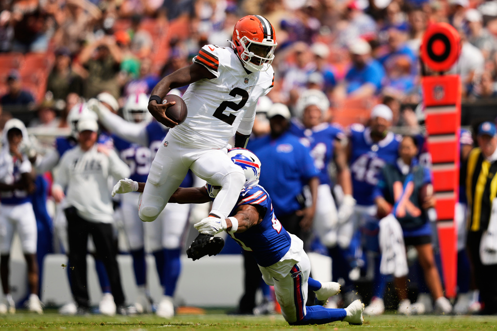 Cleveland Browns quarterback Shedeur Sanders (2) is tackled by Buffalo Bills cornerback Davison Igbinosun (21) during the first half of an NFL preseason football game, Saturday, Aug. 22, 2026, in Cleveland. (AP Photo/Carolyn Kaster)