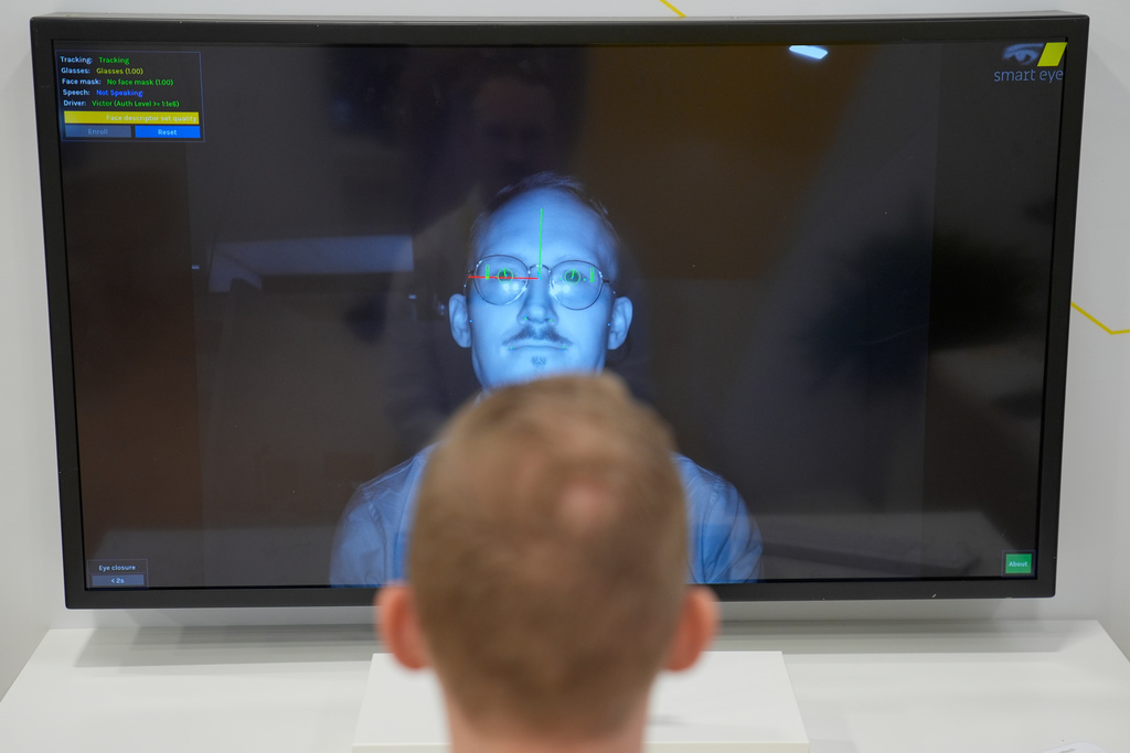 People take part in a simulator for the Smart Eye iris authentication system at the Smart Eye booth during the CES tech show Tuesday, Jan. 6, 2026, in Las Vegas. (AP Photo/John Locher)