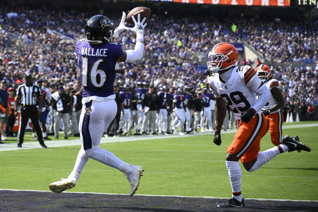 Baltimore Ravens wide receiver Tylan Wallace scores ahead of Cleveland Browns cornerback Cameron Mitchell during the first half of an NFL football game, Sunday, Sept. 14, 2025, in Baltimore. (AP Photo/Nick Wass)
