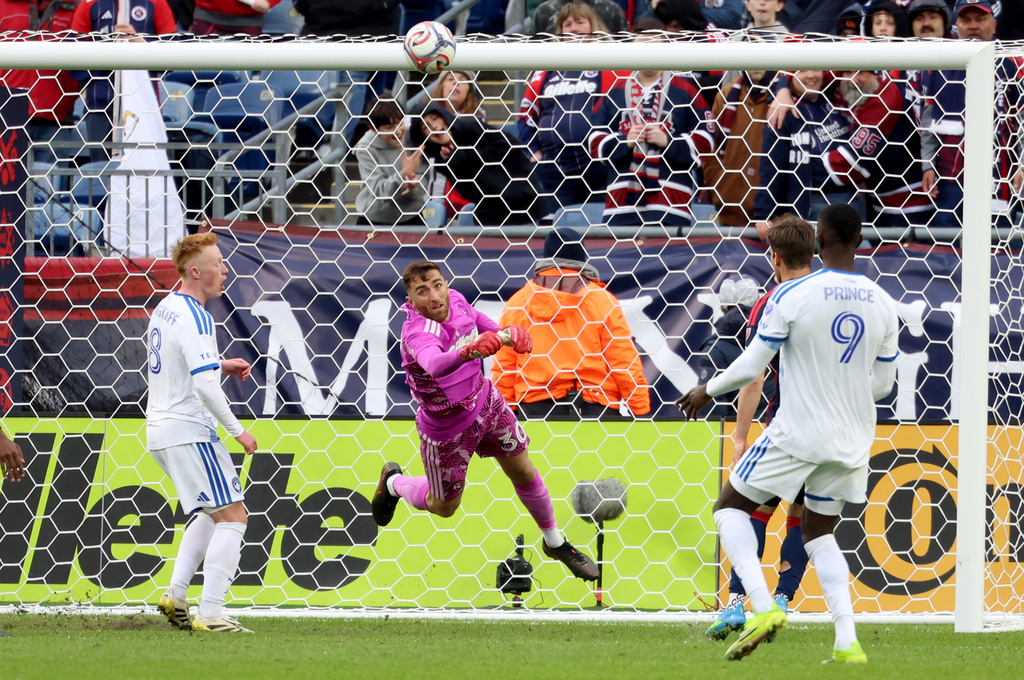 New England Revolution goalkeeper Matt Turner punches the ball away from the net in the first half of an MLS soccer match against CF Montreal, Saturday, April 4, 2026, in Foxborough, Mass. (AP Photo/Mark Stockwell)