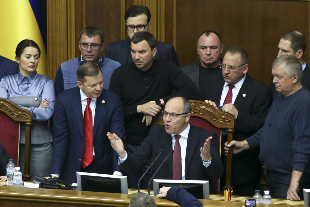 FILE - Ukrainian lawmakers listen to parliament speaker Andriy Parubiy, center, during a parliament session in Kiev, Ukraine, Monday, Nov. 26, 2018. (AP Photo/Efrem Lukatsky, file)