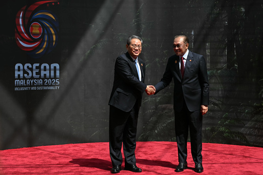 China's Premier Li Qiang, left, shakes hands with Malaysia's Prime Minister Anwar Ibrahim as he arrives at the Kuala Lumpur Convention Centre to attend the 47th Association of Southeast Asian Nations (ASEAN) summit in Kuala Lumpur, Malaysia, Monday, Oct. 27, 2025. (Lillian Suwanrumpha/Pool Photo via AP) China's Premier Li Qiang, left, shakes hands with Malaysia's Prime Minister Anwar Ibrahim as he arrives at the Kuala Lumpur Convention Centre to attend the 47th Association of Southeast Asian Nations (ASEAN) summit in Kuala Lumpur, Malaysia, Monday, Oct. 27, 2025. (Lillian Suwanrumpha/Pool Photo via AP)