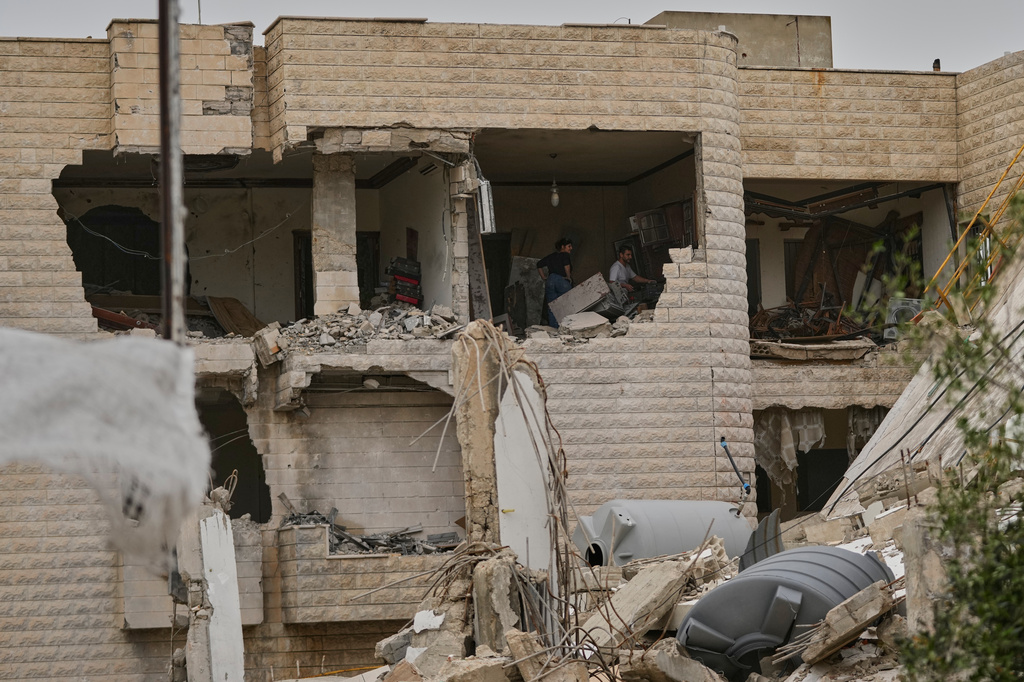 Residents remove rubble from their destroyed house on the second day of a ceasefire between Hezbollah and Israel in Nabatiyeh town, south Lebanon, Saturday, April 18, 2026.(AP Photo/Mohammed Zaatari)