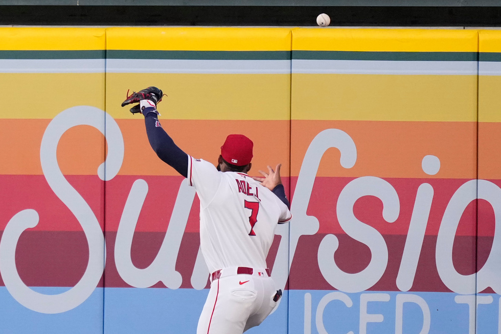 Los Angeles Angels right fielder Jo Adell misplays a ball hit by Colorado Rockies' TJ Rumfield that hit him in the head and then bounced out for a solo home run during the fourth inning of a baseball game Tuesday, June 2, 2026, in Anaheim, Calif. (AP Photo/Mark J. Terrill)
