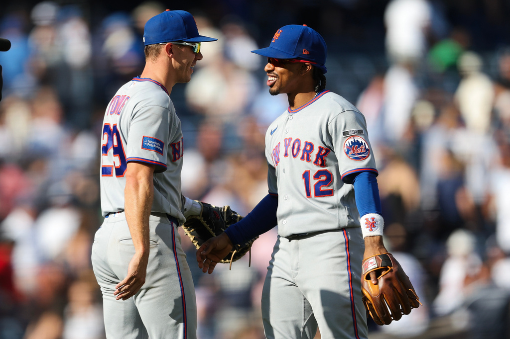 New York Mets' Jared Young (29) and Francisco Lindor (12) come together following a win over the New York Yankees after the ninth inning of a baseball game, Saturday, Sept. 12, 2026, in New York. (AP Photo/Heather Khalifa)