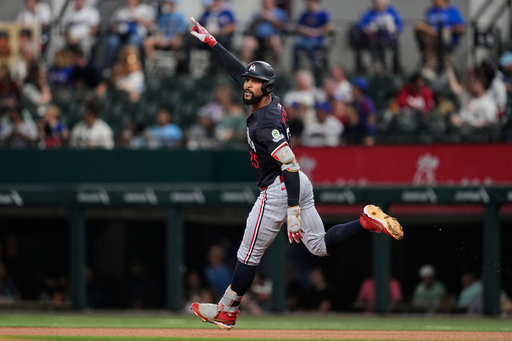 Minnesota Twins' Byron Buxton celebrate after hitting a solo home run in the first inning of a baseball game against the Texas Rangers Wednesday, Sept. 24, 2025, in Arlington, Texas. (AP Photo/Tony Gutierrez)