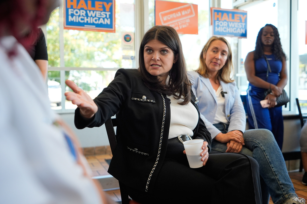 Rep. Haley Stevens, D-Mich., a candidate in the Democratic primary for U.S. Senate in Michigan, speaks during a campaign event at Corine's Soul Food, Cakes & Catering Monday, Aug. 3, 2026, in Muskegon Heights, Mich., as Rep. Hillary Scholten, D-Mich., right, listens (AP Photo/Paul Sancya)