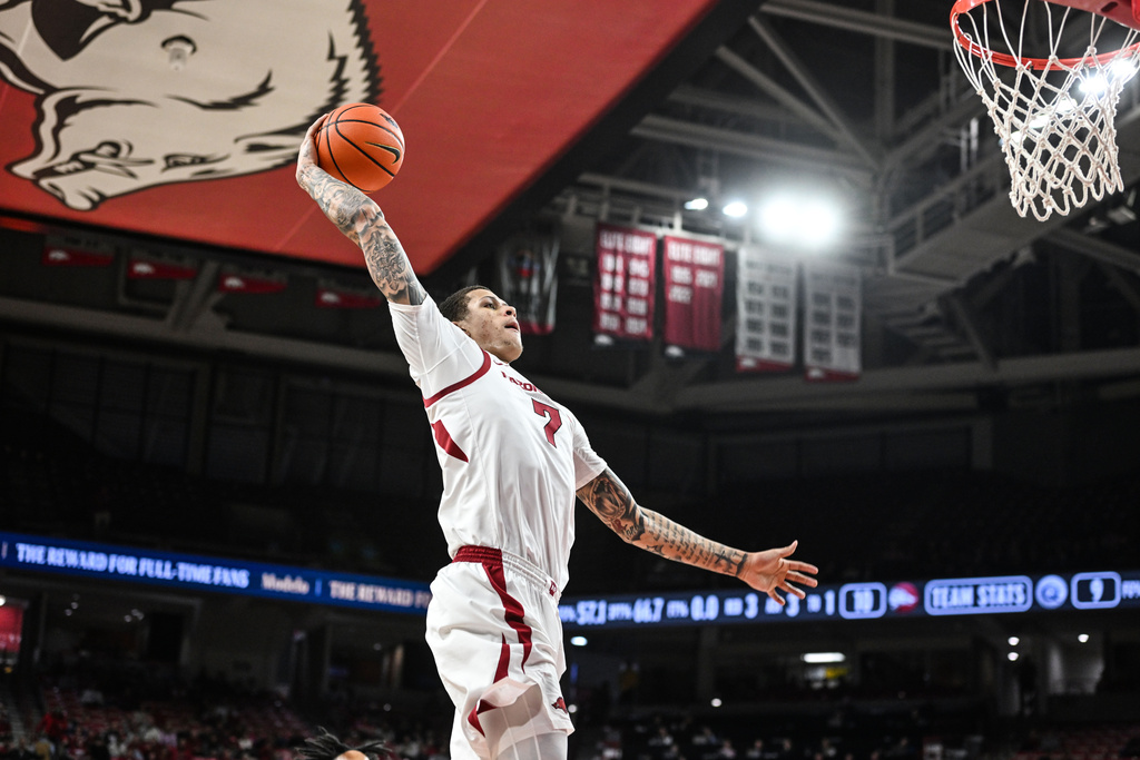 Arkansas forward Trevon Brazile (7) dunks the ball on a fast break against Queens during the first half of an NCAA college basketball game Tuesday, Dec. 16, 2025, in Fayetteville, Ark. (AP Photo/Michael Woods)