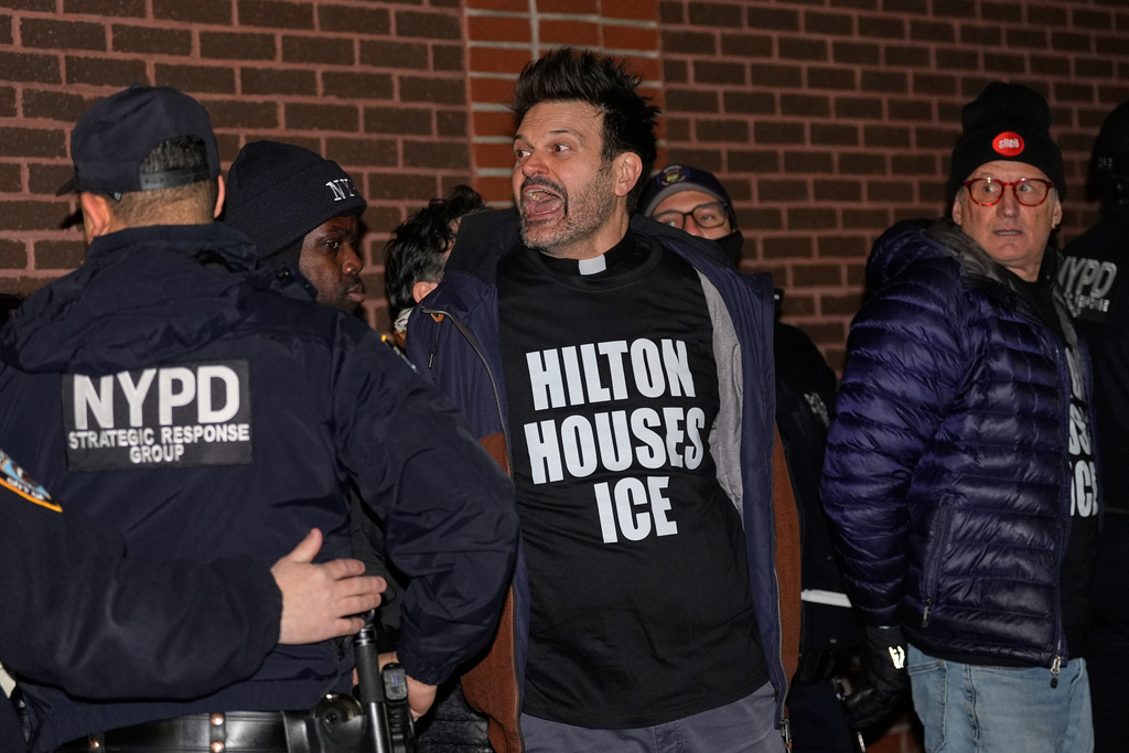 A protesters yells after being arrested for participating in a sit-in at the lobby of a Hilton Garden Inn in New York, Tuesday, Jan. 27, 2026. (AP Photo/Seth Wenig)