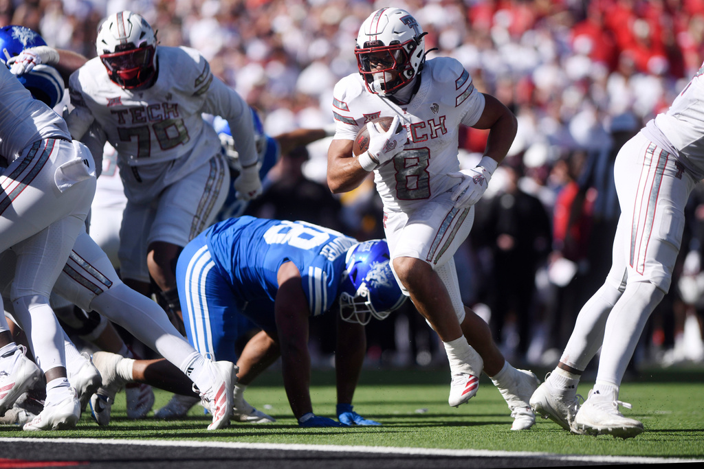 Texas Tech running back Cameron Dickey (8) runs for a touchdown during the second half of an NCAA college football game against BYU, Saturday, Nov. 8, 2025, in Lubbock, Texas. (AP Photo/Annie Rice)
