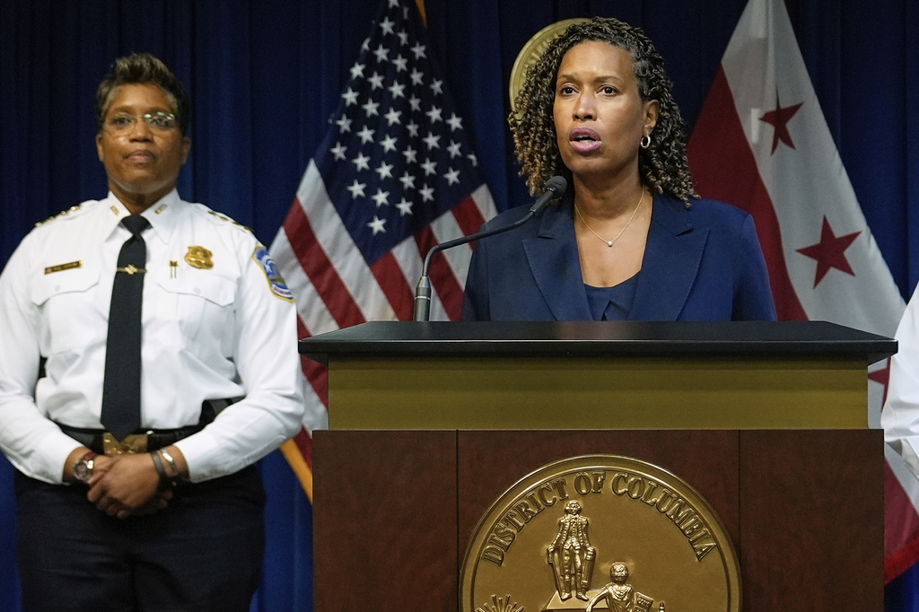 Washington Mayor Muriel Bowser speaks as Metropolitan Police Department Chief Pamela A. Smith listens during a news conference on President Donald Trump's plan to place Washington police under federal control and deploy National guard troops to Washington, Monday, Aug. 11, 2025, in Washington. (AP Photo/Julia Demaree Nikhinson)