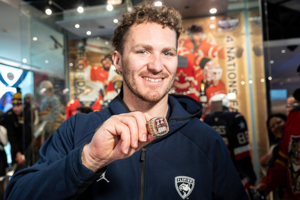 Florida Panthers' Matthew Tkachuk shows fans the team's 2025 Stanley Cup ring before placing it inside the display at the Hockey Hall of Fame in Toronto, Canada, on Tuesday, Jan. 6, 2025. (Eduardo Lima/The Canadian Press via AP)
