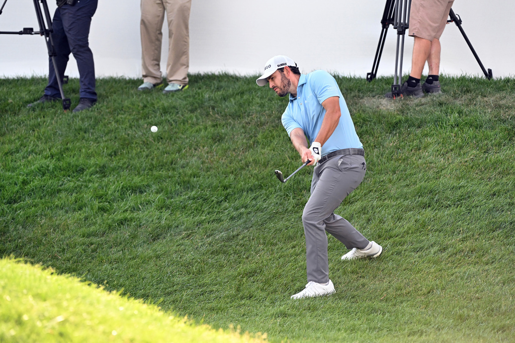 Patrick Cantlay chips onto the 18th green during the first round of the Rocket Classic golf tournament at the Detroit Golf Club, Thursday, July 30, 2026, in Detroit. (AP Photo/Jose Juarez)