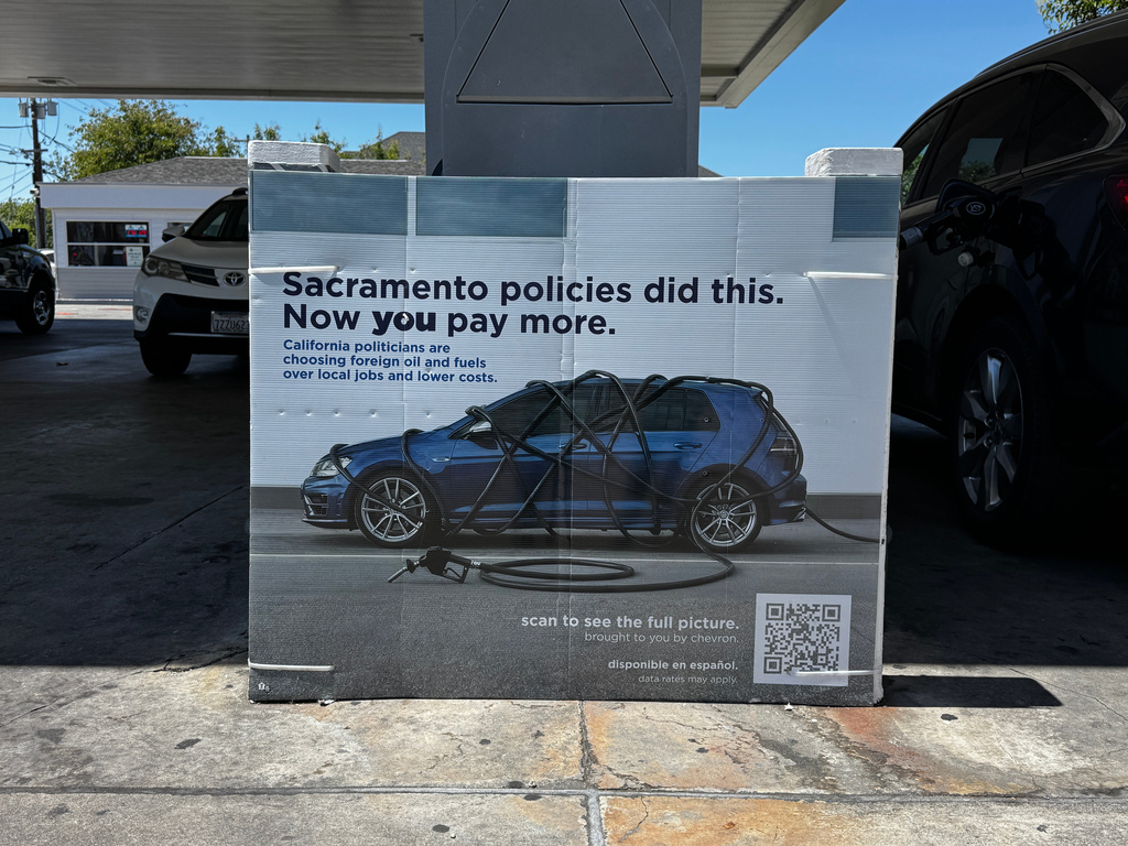 A sign blaming Sacramento policies for high gas prices is displayed at a Chevron gas station in Alameda, Calif., on Thursday, May 21, 2026. (AP Photo/Terry Chea)