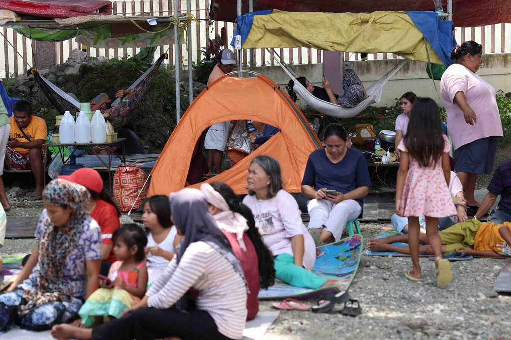 Residents take shelter in a field at a municipal hall in Sarangani province, Philippines, Wednesday, June 10, 2026. (AP Photo/Basilio Sepe)