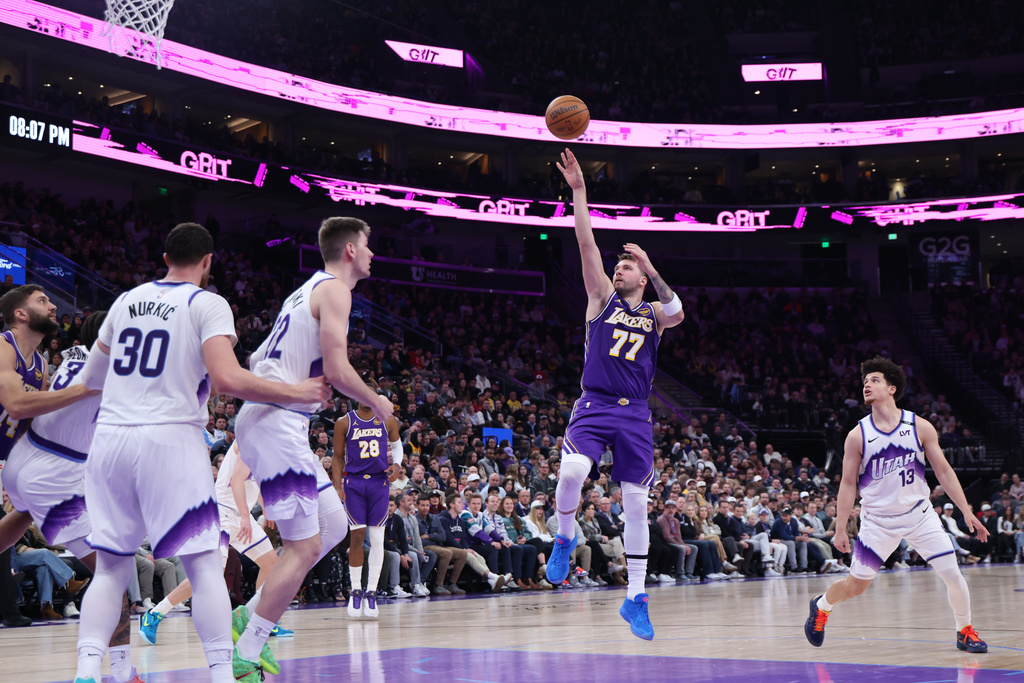 Los Angeles Lakers guard Luka Doncic (77) shoots against the Utah Jazz during the first half of an NBA basketball game, Thursday, Dec. 18, 2025, in Salt Lake City. (AP Photo/Rob Gray)