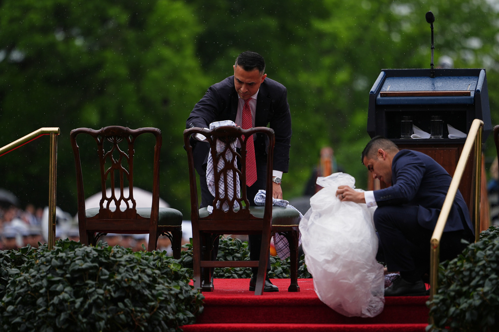 Staff dry off chairs ahead of a State Visit arrival ceremony on the South Lawn of the White House, Tuesday, April 28, 2026, in Washington. (AP Photo/Julia Demaree Nikhinson)