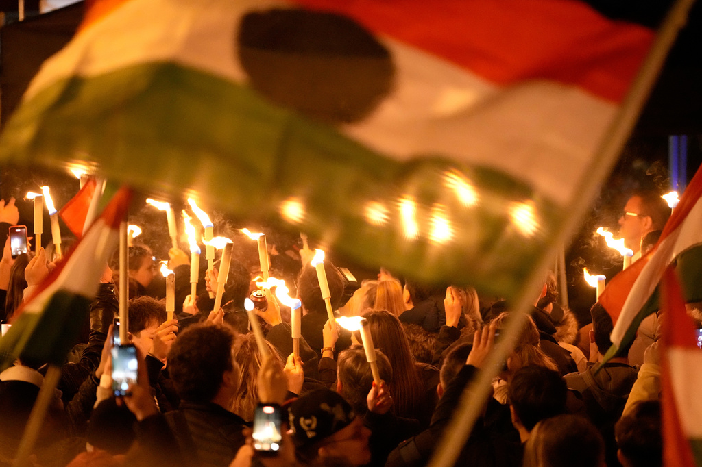 Supporters of Peter Magyar, the leader of the opposition Tisza party celebrate after a parliamentary election in Budapest, Hungary, Sunday, April 12, 2026. (AP Photo/Darko Bandic)