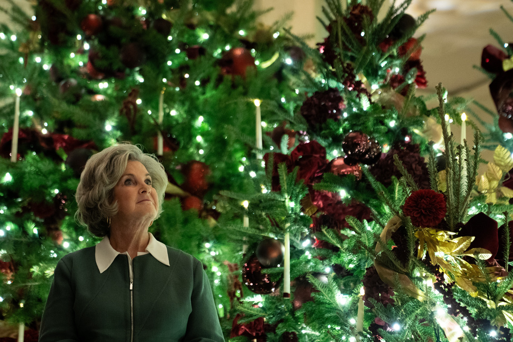 White House Chief of Staff Susie Wiles looks up surrounded by Christmas Trees at the White House, Friday, Dec. 5, 2025, in Washington. (AP Photo/Allison Robbert)