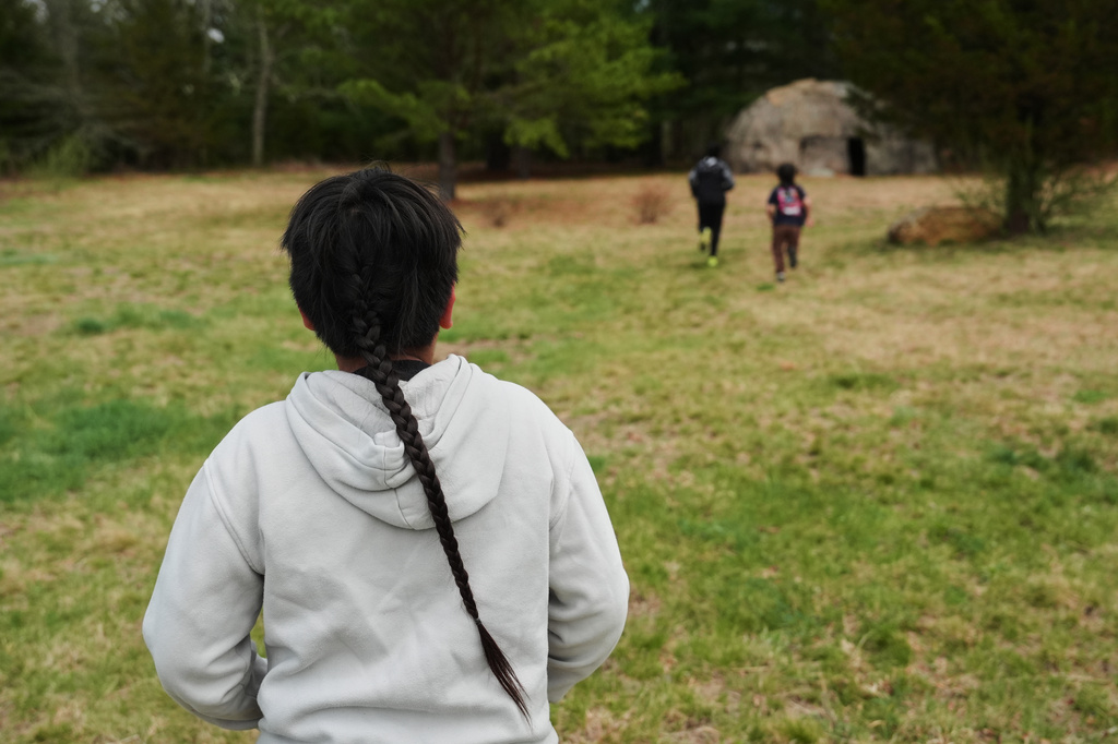 Sowaniu Spears, 11, runs toward a Wetu, a traditional Native American dwelling, Tuesday, April 21, 2026, at his grandparents' farm in Hopkinton, R.I. (AP Photo/Joshua A. Bickel)