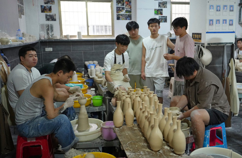 Students practice traditional ceramic craftsmanship at Zhan Shao Ceramic Arts Practice Base in Jingdezhen, in eastern China's Jiangxi province, Tuesday, Sept. 1, 2026. (AP Photo/Achmad Ibrahim)